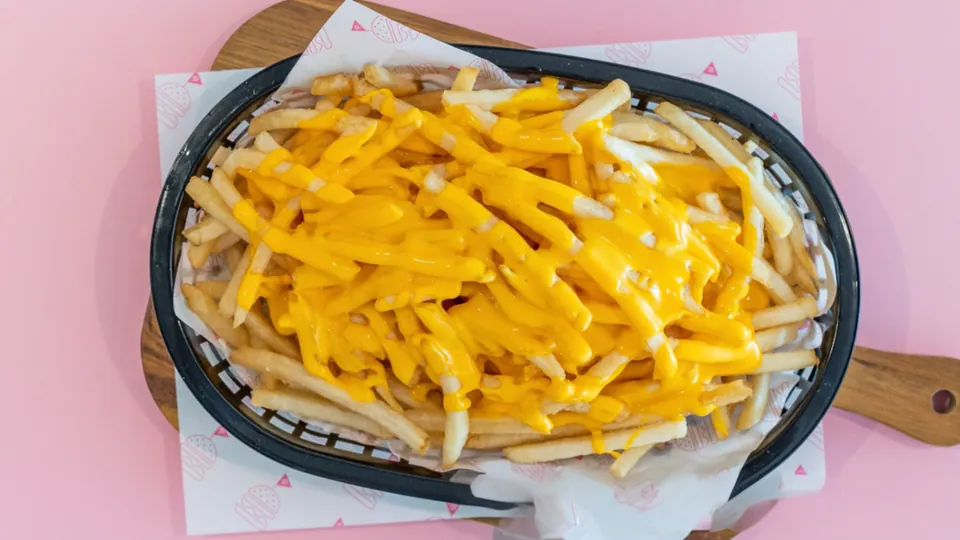 Cheesy Fries – Thin + crispy fries topped with cheesy sauce.