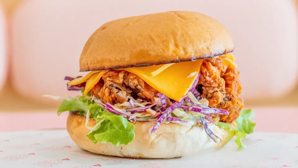 Hot Chic – Grandma Pearls spicy fried chicken, house made slaw, cheese, lettuce, Louisiana hot sauce, mayo + spicy pickles.