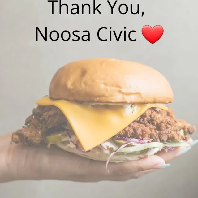 Crispy fried chicken burger held up to the camera